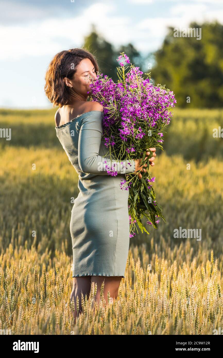 Donna Castana In Vestito Porpora Nel Giacimento Di Grano Al Tramonto  Immagini e Fotos Stock - Alamy