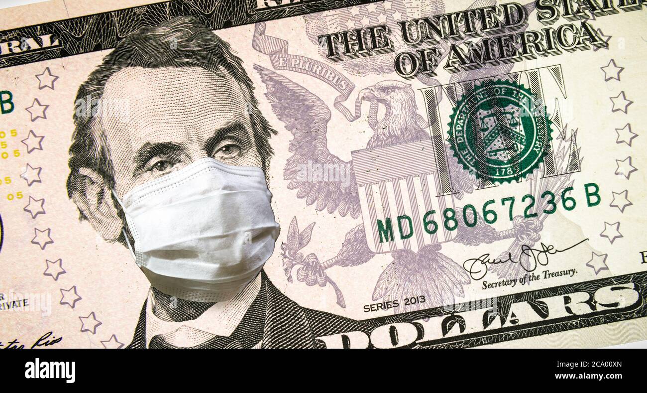 Coronavirus negli Stati Uniti, presidente Lincoln con maschera facciale su un conto di 5 dollari in denaro. COVID-19 colpisce il mercato azionario globale, l'economia colpita da pandemi virus corona Foto Stock