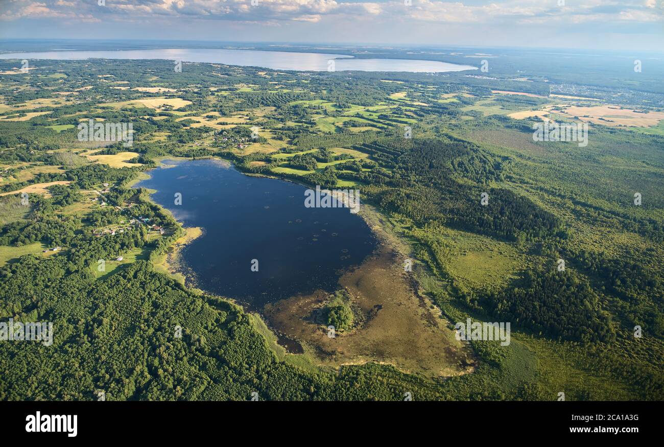 Foresta e lago paesaggio aereo drone vista in giornata di sole Foto Stock