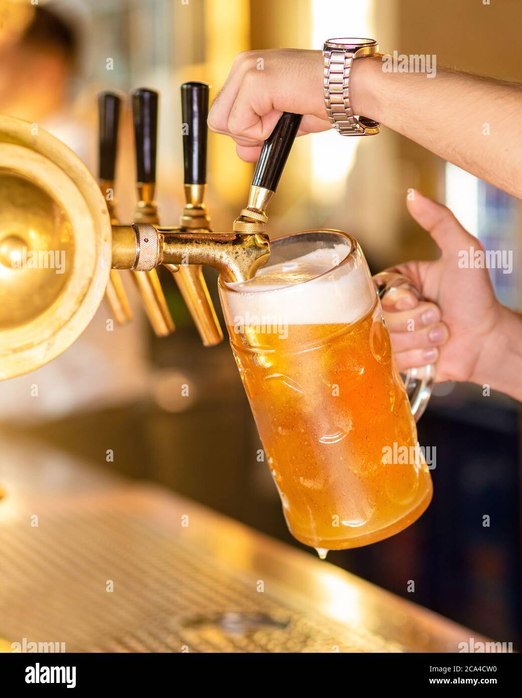 Versatore, riempimento bicchiere di birra, tazza Foto Stock