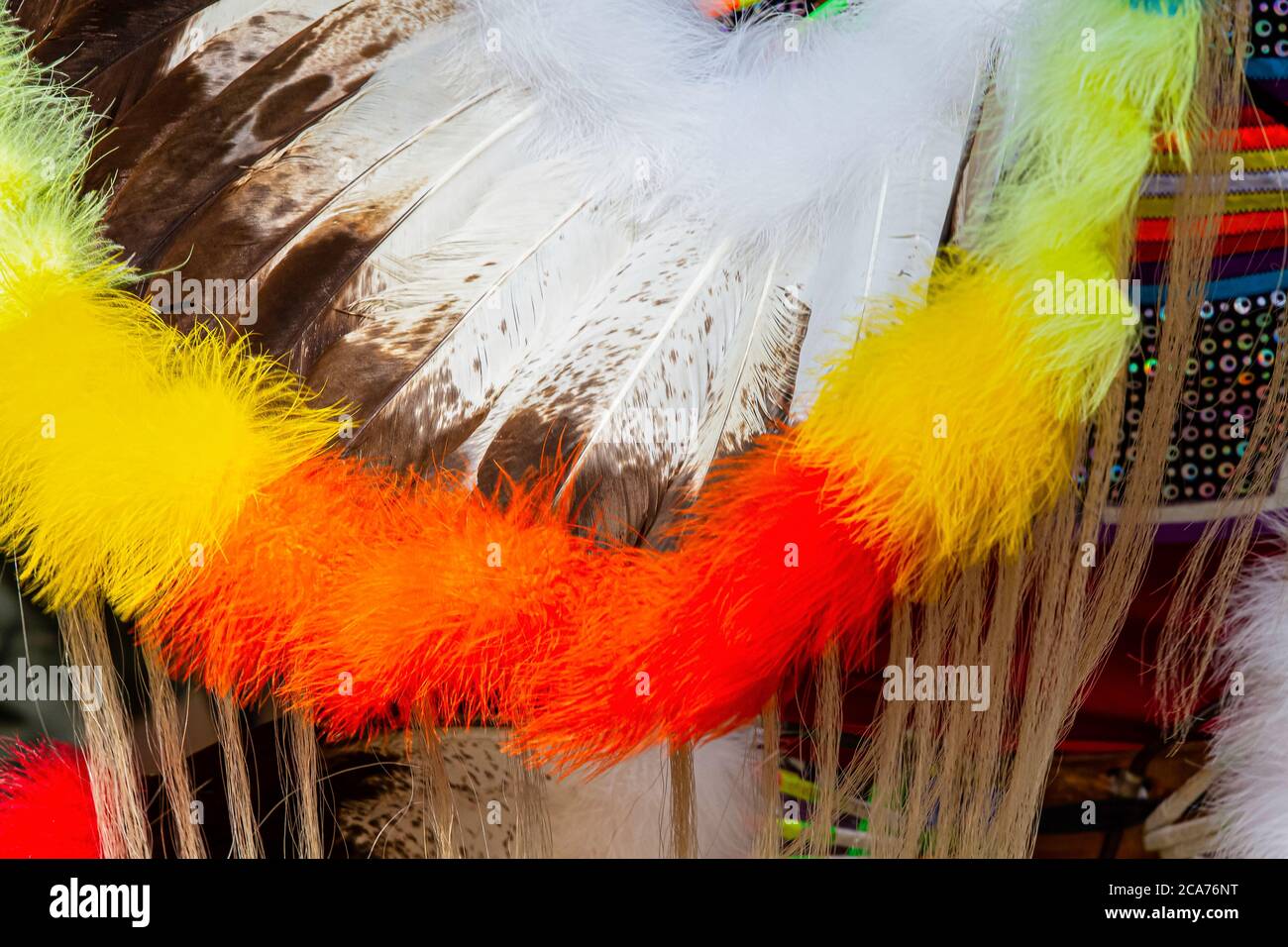 Keshena, Wisconsin, Stati Uniti. 2019-08-03 Annual Menominee Nation Pow Wow. Primo piano di un colorato abito da testa nativo con piume, pelliccia e perline. Foto Stock