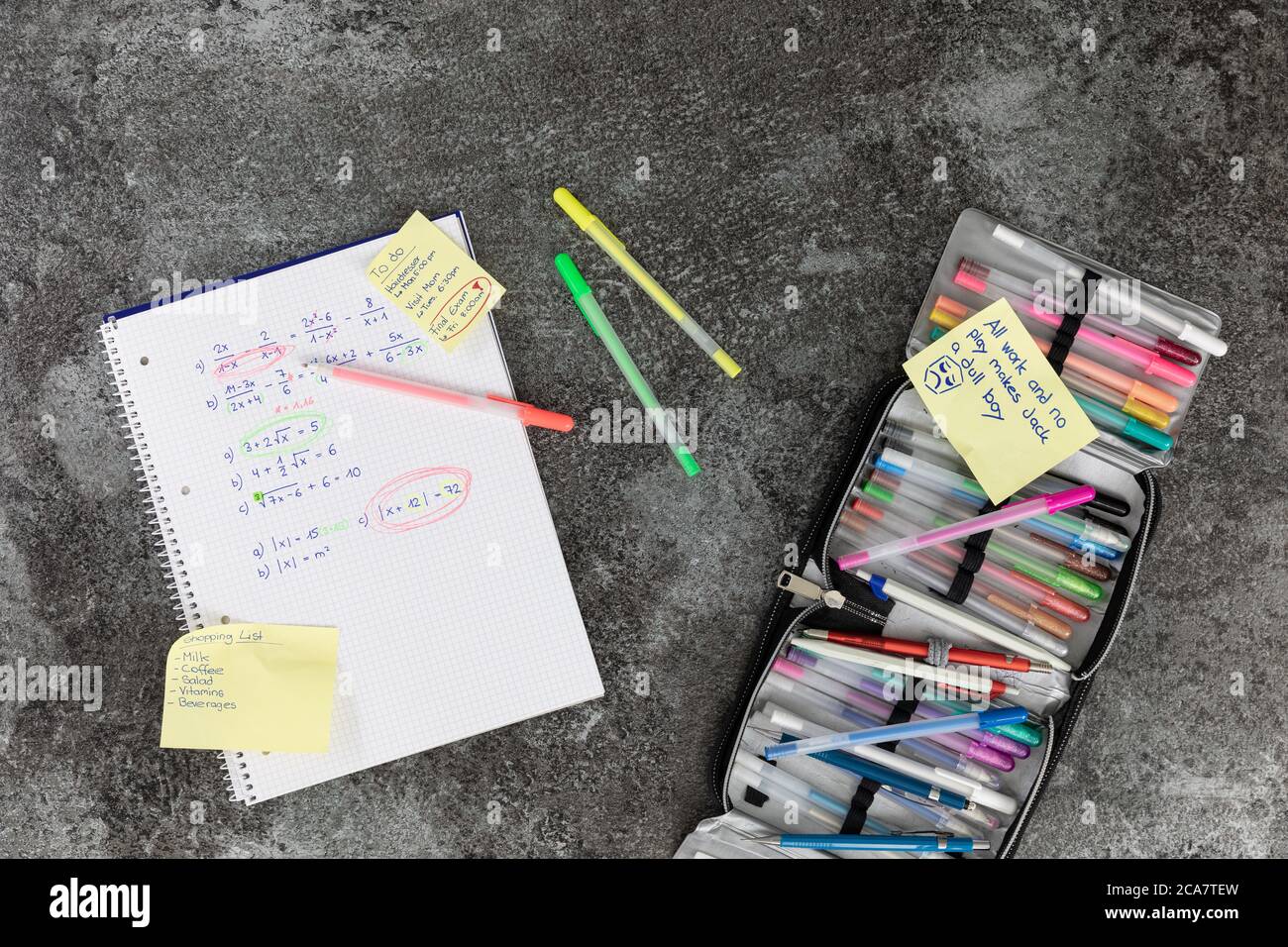 Mathematics book written by hand with arithmetic problems and pencil case, to do list, marble table Foto Stock