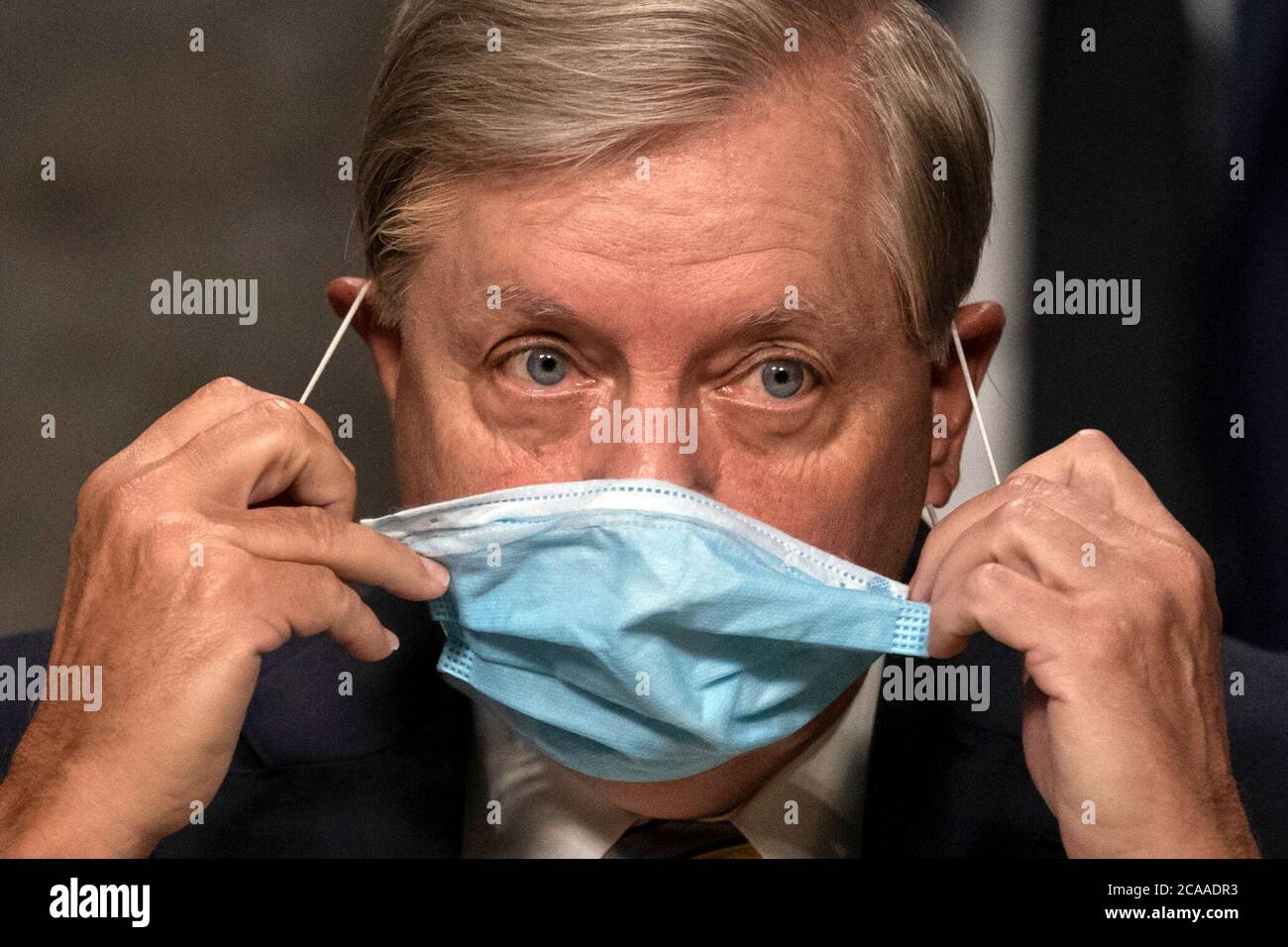 Il senatore degli Stati Uniti Lindsey Graham (repubblicano della Carolina del Sud), presidente del Comitato giudiziario del Senato degli Stati Uniti, rimuove la sua maschera quando arriva per l'audizione di supervisione del Comitato giudiziario del Senato degli Stati Uniti su Capitol Hill a Washington, mercoledì 5 agosto 2020, per esaminare l'indagine Crossfire Hurricane. Credit: Carolyn Kaster/Pool via CNP | utilizzo in tutto il mondo Foto Stock