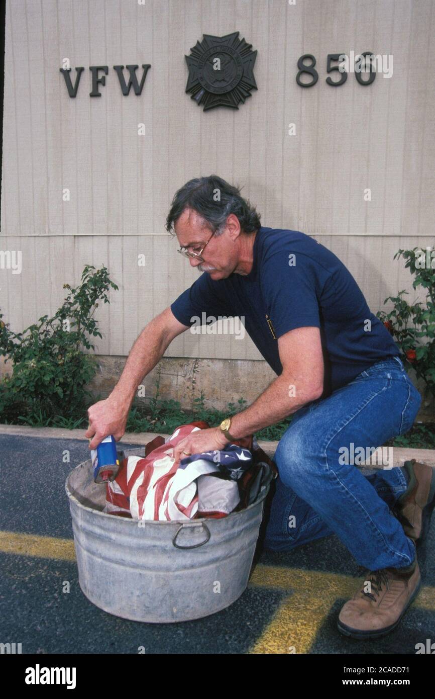 I veterani anglo-maschili mostrano il modo corretto per smaltire le vecchie bandiere americane nella sala VFW (Veterans of Foreign Wars) di Austin, Texas. ©Bob Daemmrich Foto Stock