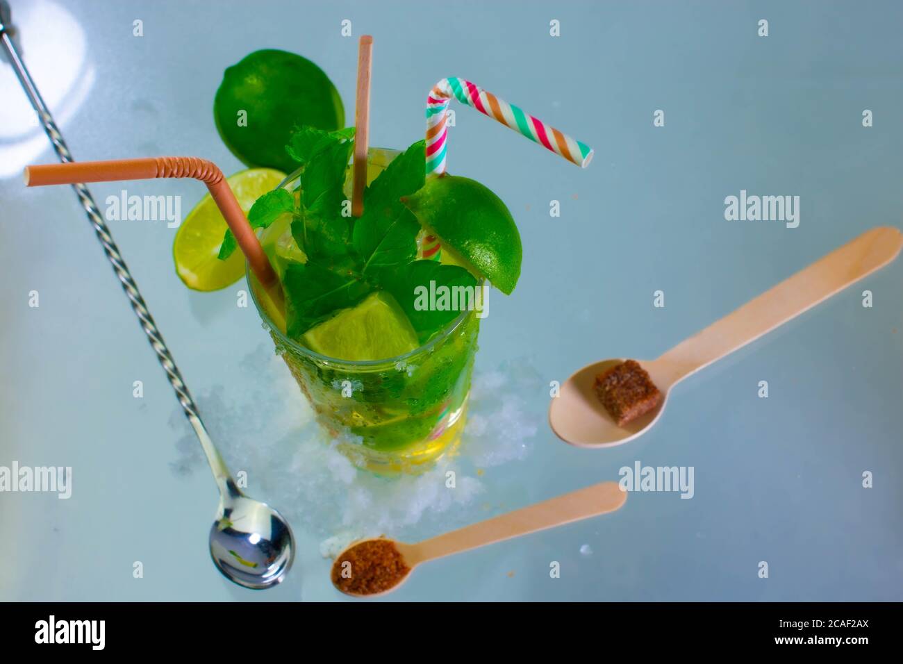 Cocktail Mojito con rum, lime e foglie di menta su un tavolo di vetro Foto Stock
