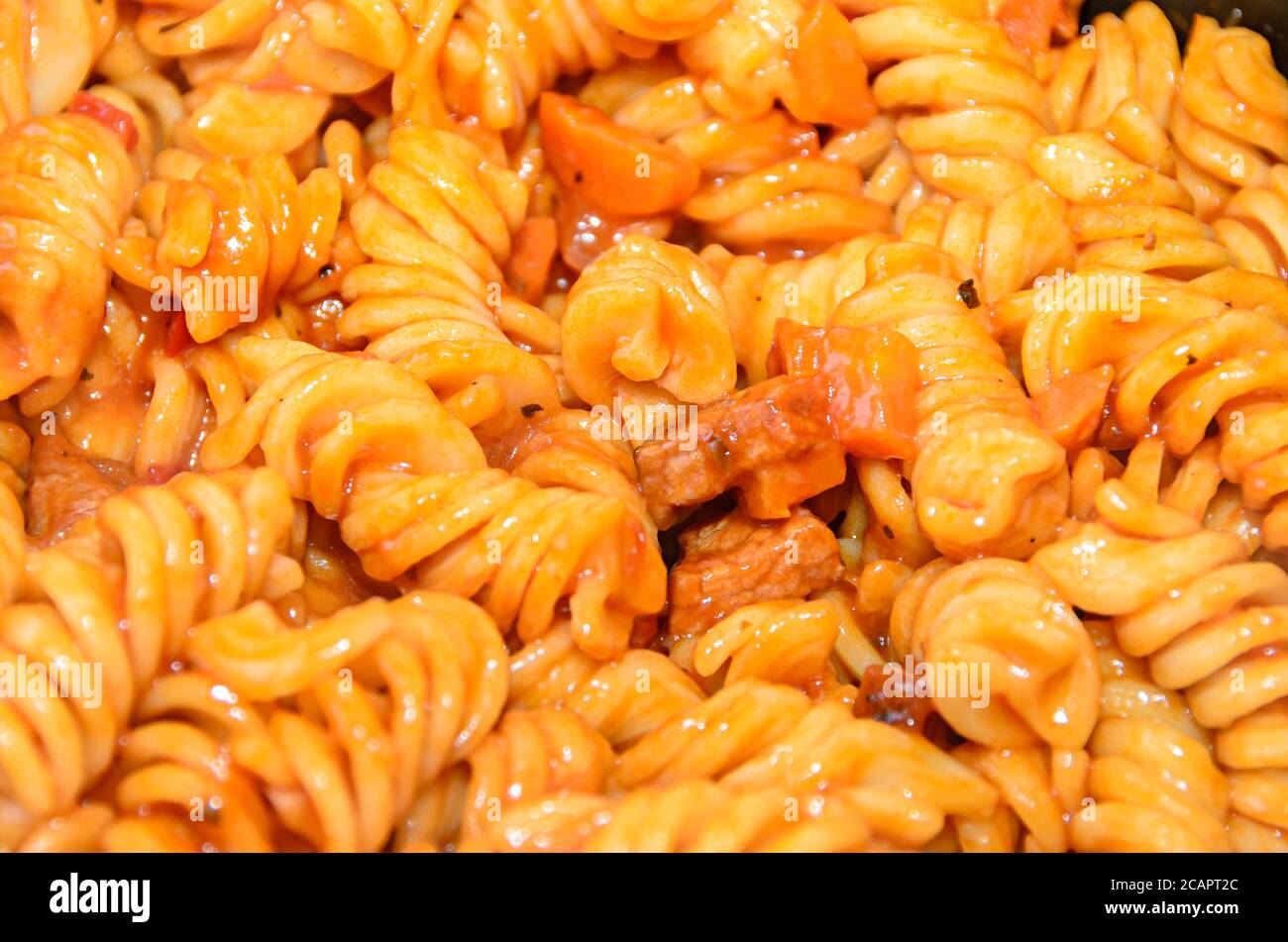 Spaghetti di pasta con salsa di pomodoro rosso, arrabiata con funghi, pancetta, parmezan. Foto Stock