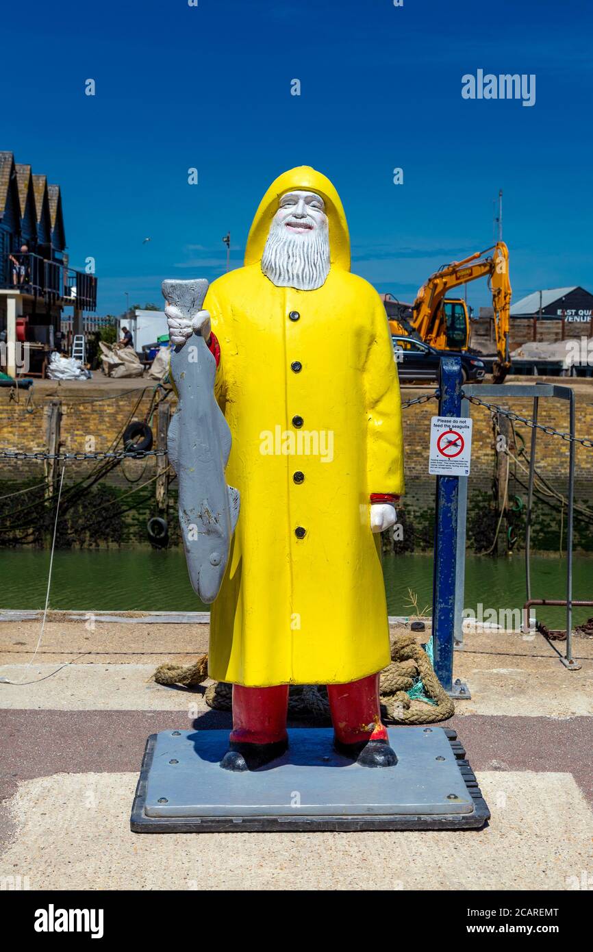 Statua del pescatore fuori dal mercato del pesce a Whitstable Harbour, Kent, Regno Unito Foto Stock