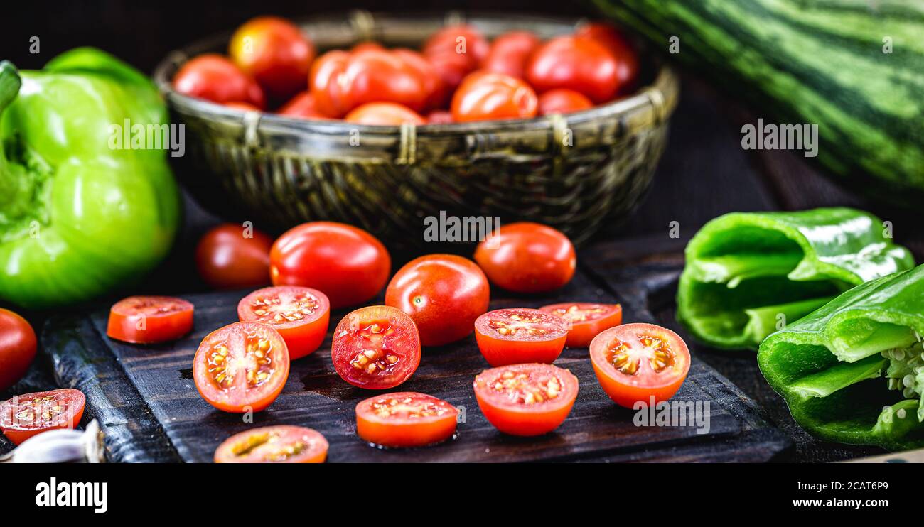 piccolo pomodoro rosso utilizzato come ingrediente culinario nella cucina rustica, pomodori tagliati a fette ​​and a dadini Foto Stock
