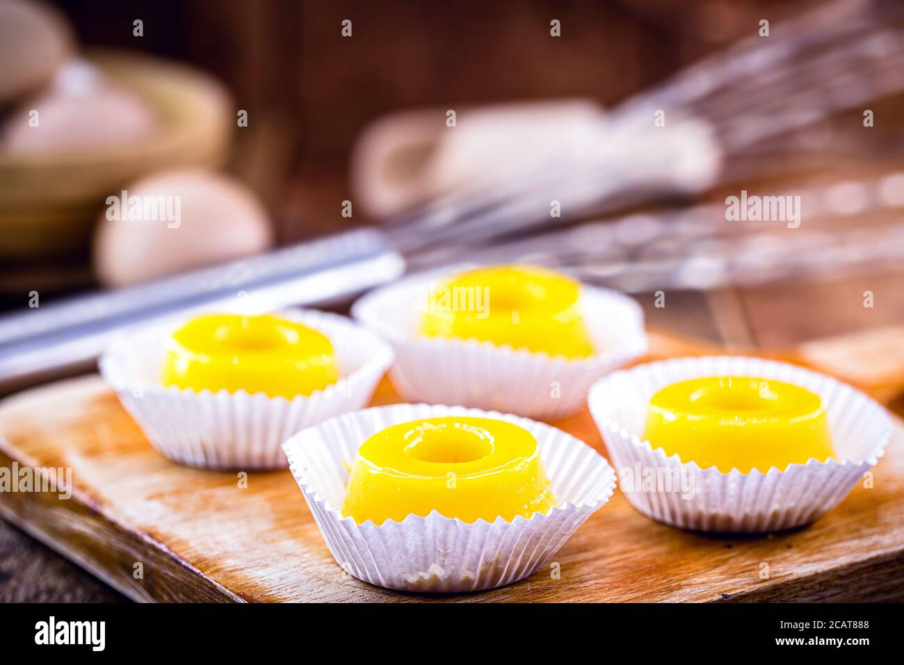 Diversi dolci chiamati 'Quindim', dolce brasiliano a base di tuorlo d'uovo, zucchero e cocco grattugiato. Dolce giallo tipico della cucina brasiliana. Foto Stock