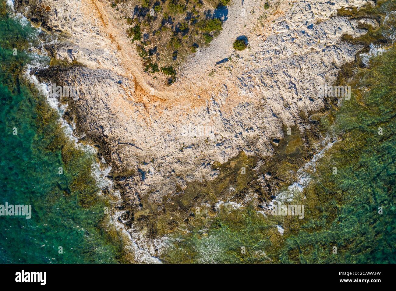 Costa adriatica in Croazia, isola Dugi otok. promontorio roccioso e superficie del mare, vista sul drone. Foto Stock