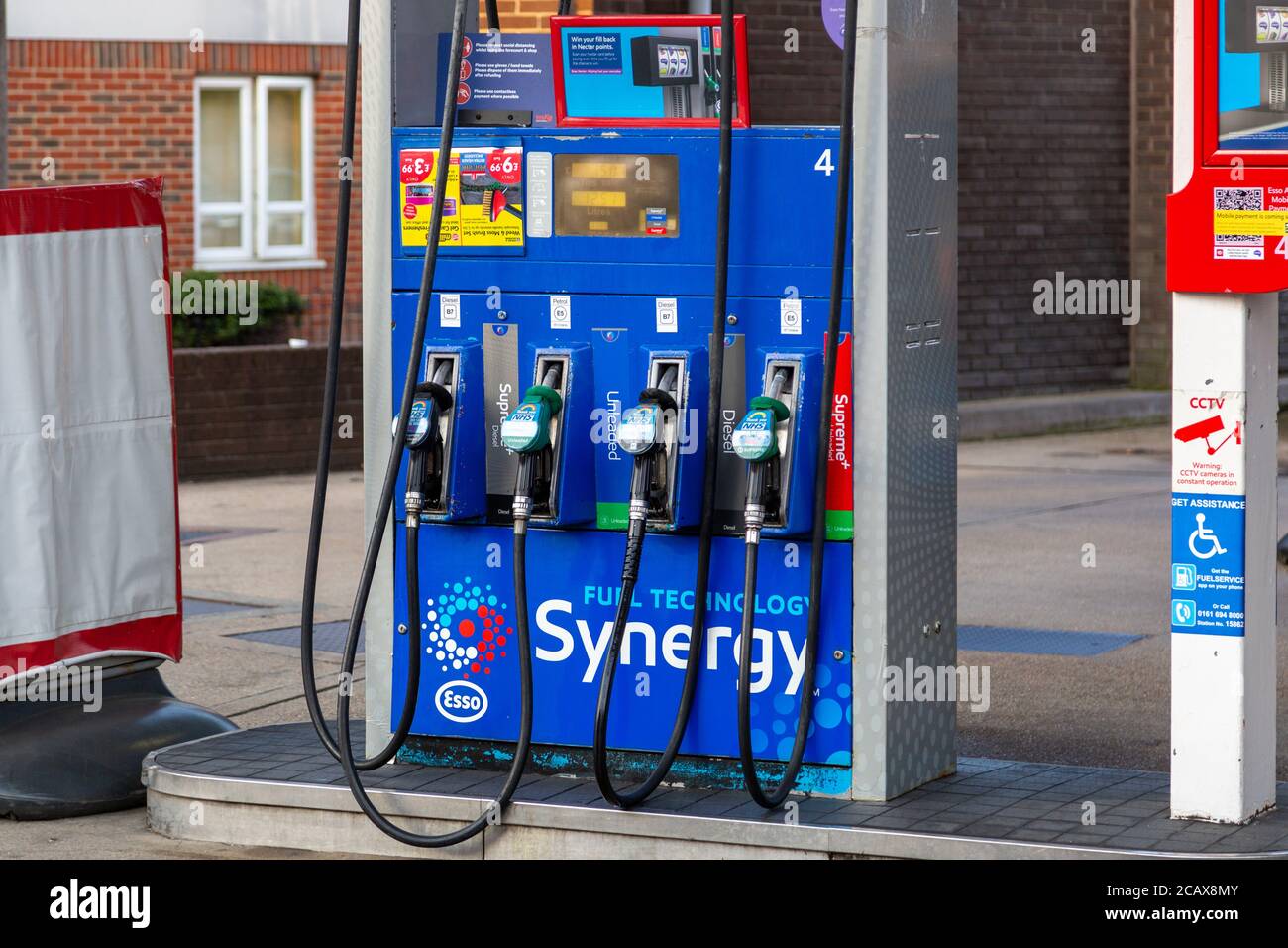 Una pompa carburante che mostra gli ugelli carburante su un piazzale di una stazione di servizio Foto Stock