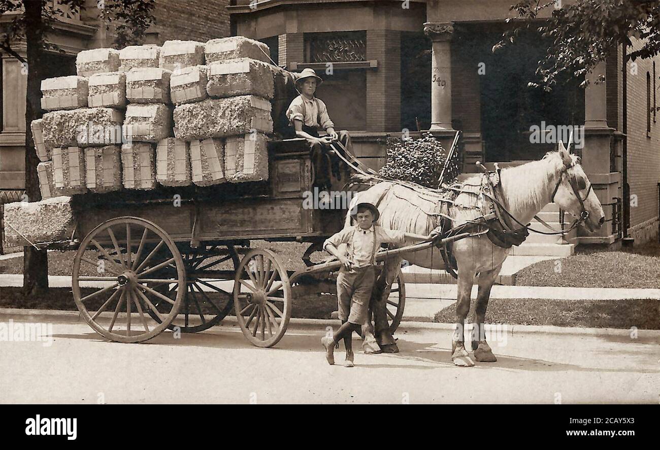 I ragazzi posano con un carro pieno di balle di cotone; circa: 1904-1915; da qualche parte nel sud Foto Stock