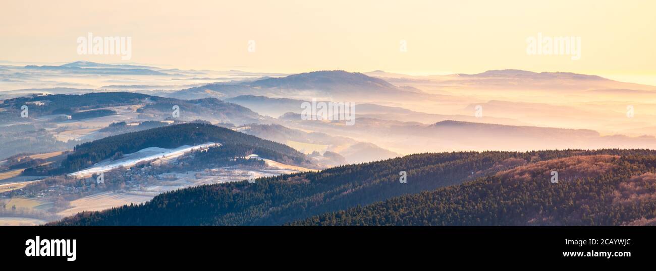 Paesaggio collinare in giornata soleggiata e nebbiosa. Inversione del tempo. Gested - crinale di Kozakov, Repubblica Ceca. Foto Stock