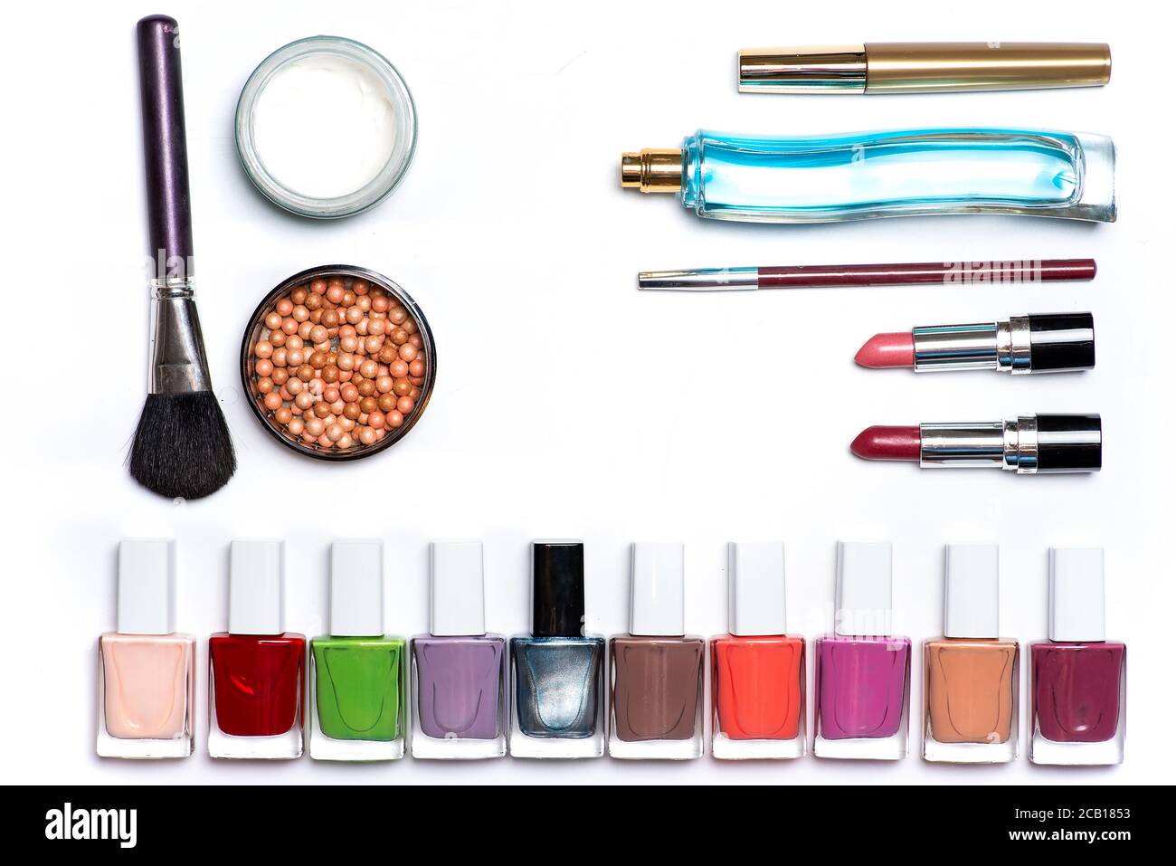 Trucco e prodotti cosmetici isolati su bianco piatto posare. Smalto per unghie palline arrossate con spazzole profumi rossetto un altro accessorio Foto Stock