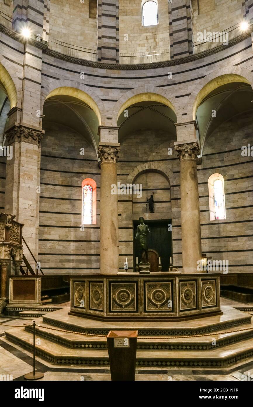 All'interno del famoso Battistero di San Giovanni. Vista frontale del fonte ottagonale del battistero con la scultura bronzea di San Giovanni Battista al... Foto Stock