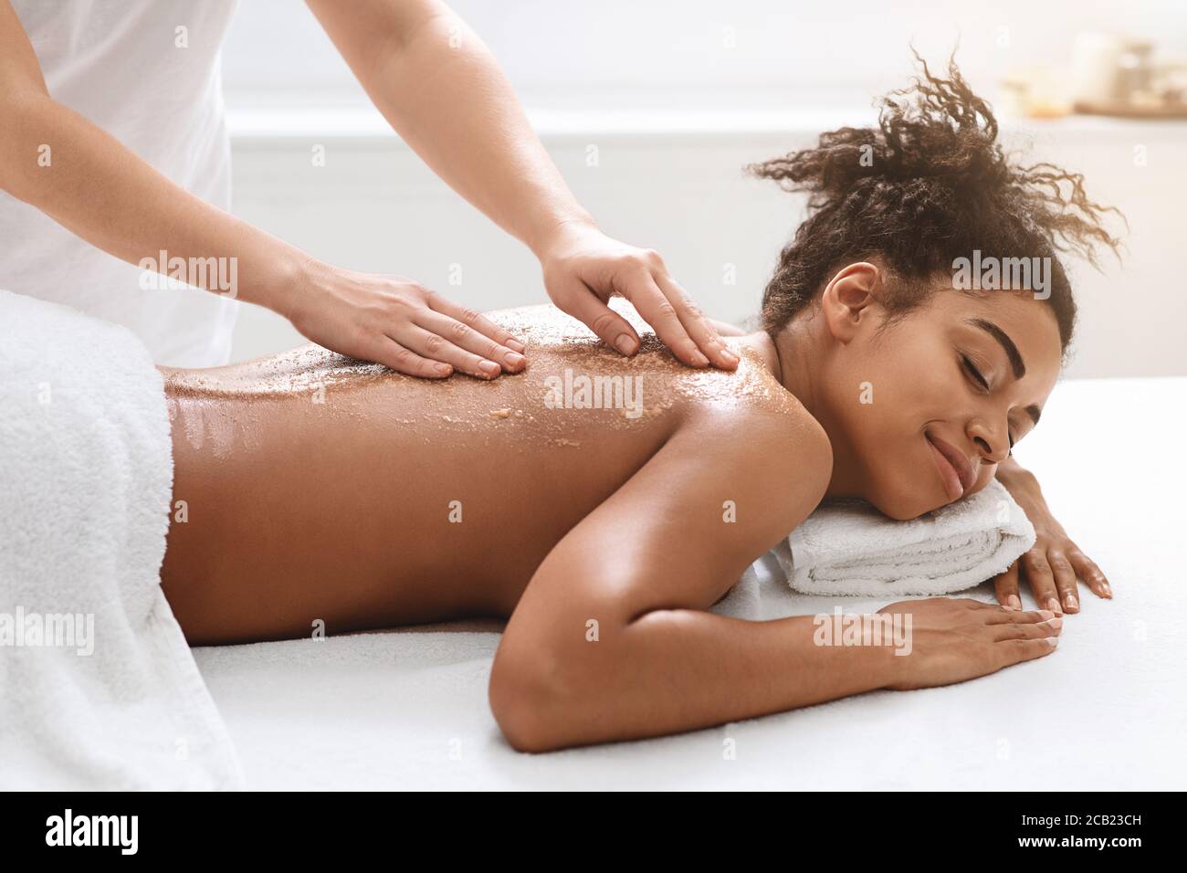 Donna di ypung nero che ottiene procedura esfoliante di bellezza Foto Stock