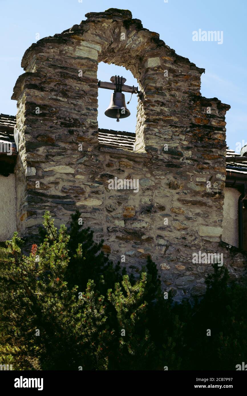 un vecchio muro di pietra con una campana in alpina Villaggio Zinal (comune Anniviers) Nel Cantone svizzero Vallese (Wallis) in estate Foto Stock