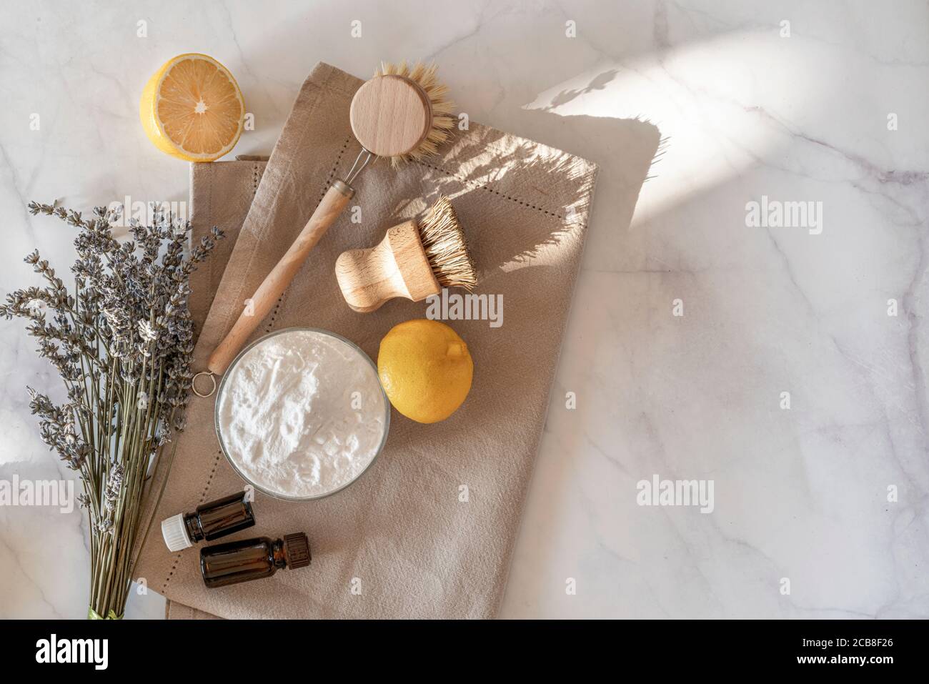 Concetto di pulizia della cucina a zero rifiuti. Utensili e prodotti ecologici per la pulizia naturale, spazzole per piatti di bambù e limone con bicarbonato di sodio. Niente plastica, stile di vita ecocompatibile. Vista dall'alto, disposizione piatta. Foto Stock