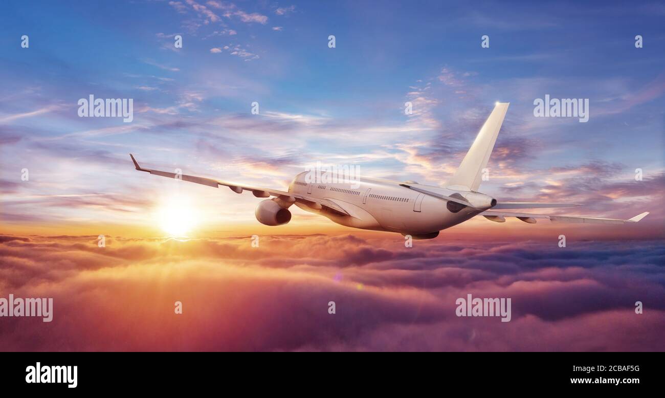 Grande aereo commerciale volare sopra le nuvole in luce del tramonto. Viaggi e business tema. Foto Stock