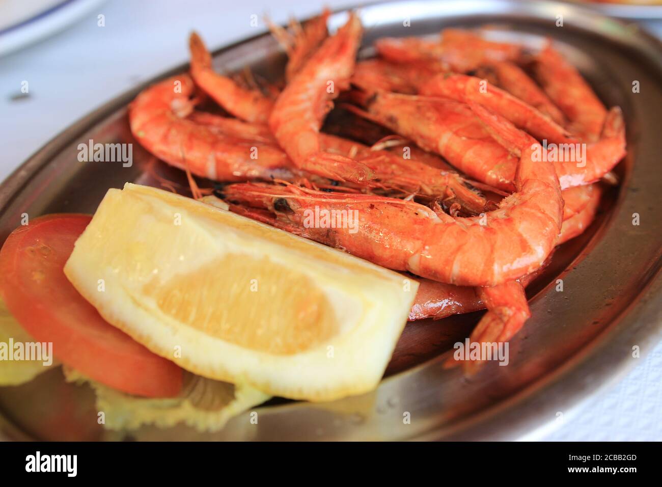 Gamberi su piatto d'argento con limone Foto Stock