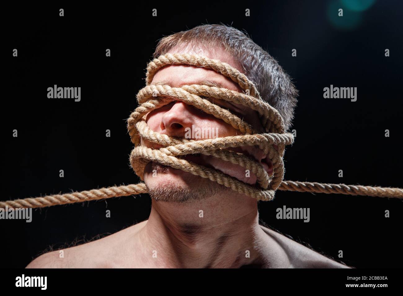 Immagine di un uomo spaventoso con corda sul viso Foto Stock