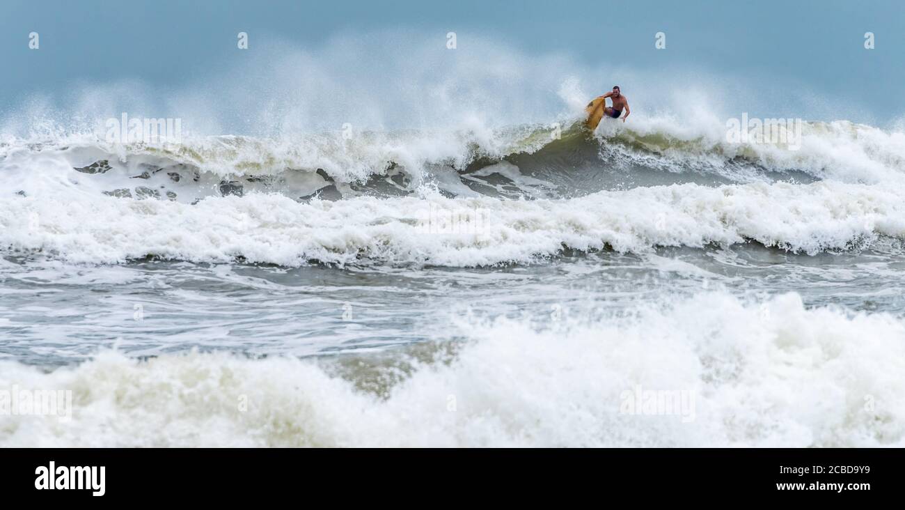 Surfista che ha pugno il labbro di un'onda a Jacksonville Beach, Florida. (STATI UNITI) Foto Stock