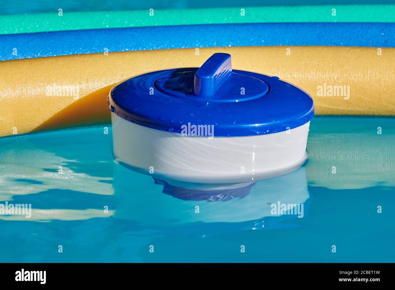 Buoi al cloro e noodle colorati in piscina. Foto Stock