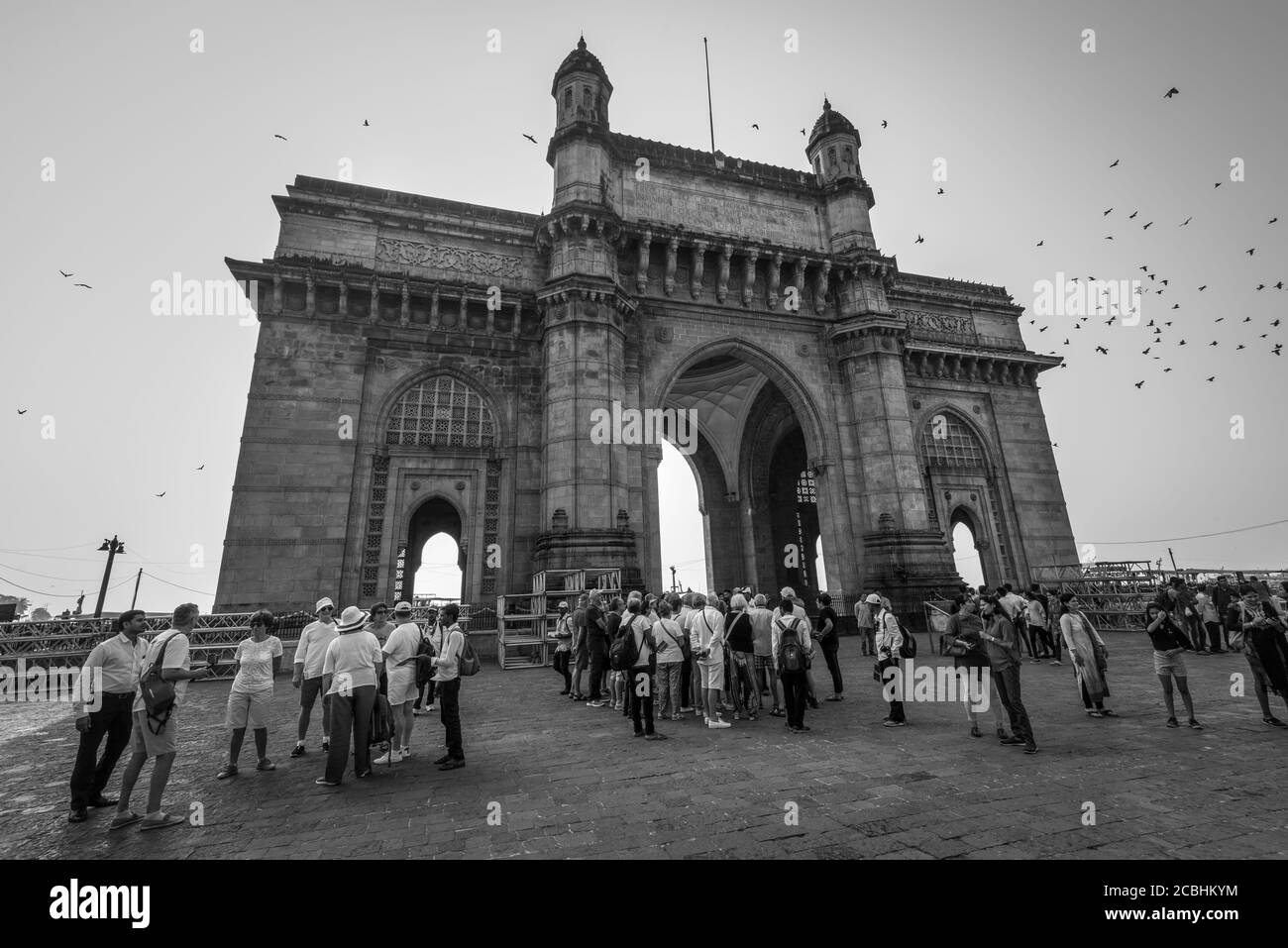 Mumbai, India - 22 novembre 2019: Porta famosa dell'India a Mumbai, India. Fotografia in bianco e nero. Folle di turisti in primo piano. Foto Stock