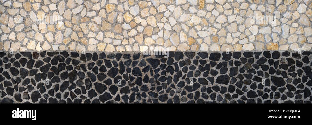 Muro di pietra design - beige sopra e nero sotto Foto Stock