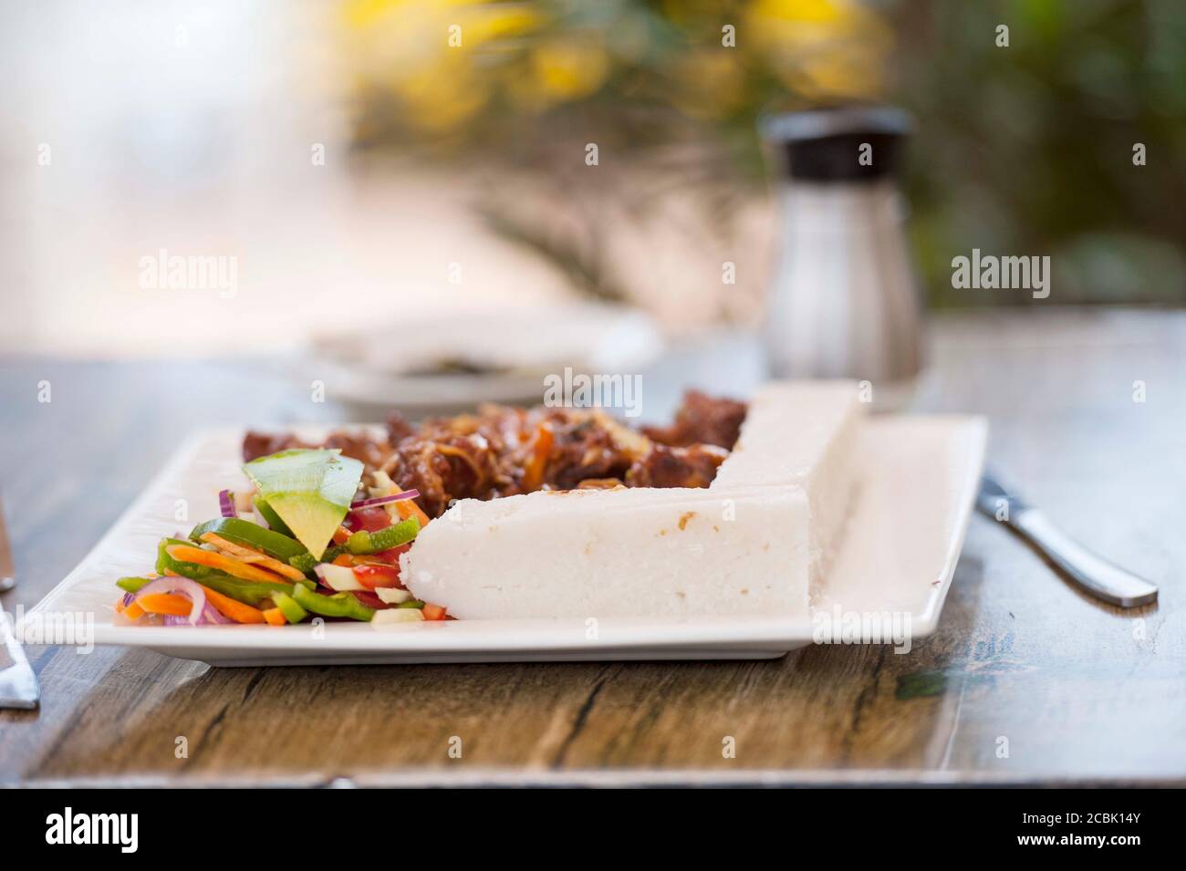 La Nsima, o ugali o posho, è un pasto principale per milioni di persone nell'Africa sub-sahariana. Mangiato popolarmente con choma di nyama, carne di capra o appena verdi Foto Stock