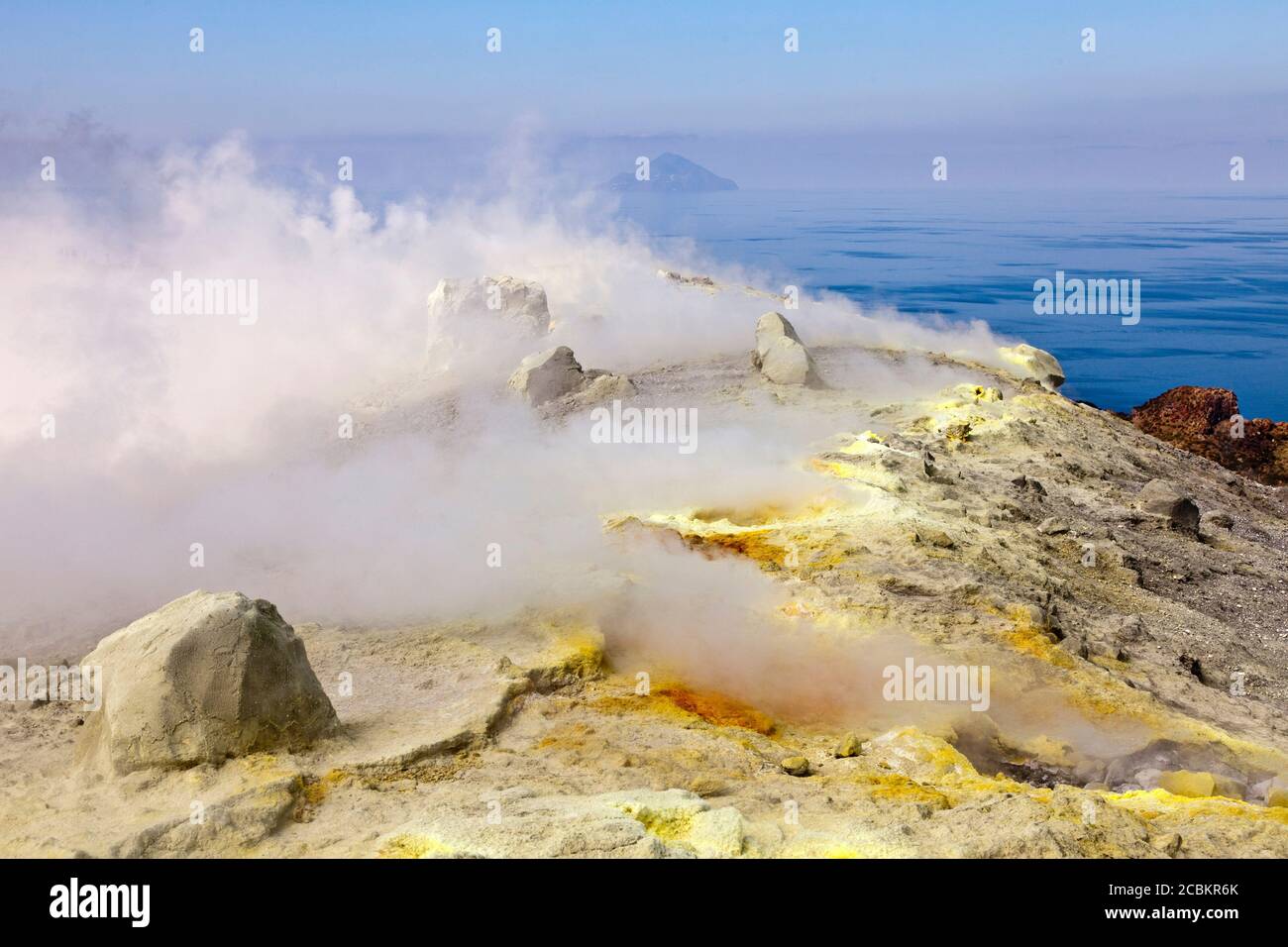 Vapore dalle sorgenti termali calde su una collina rocciosa Foto Stock