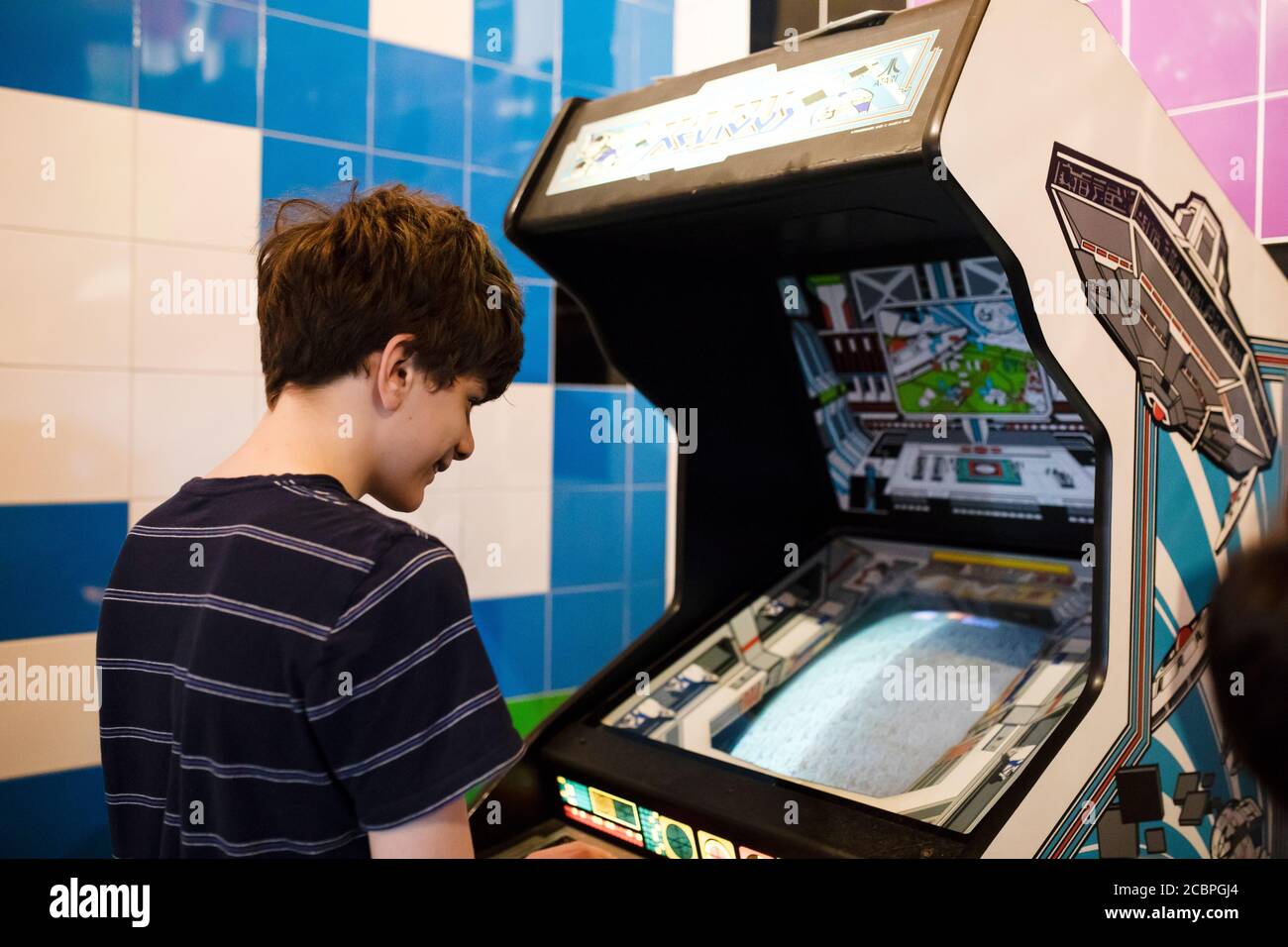 Un ragazzo di quindici anni gioca il gioco arcade Atari Xevious al Computerspiele Museum (museo dei videogiochi) di Berlino, Germania. Foto Stock