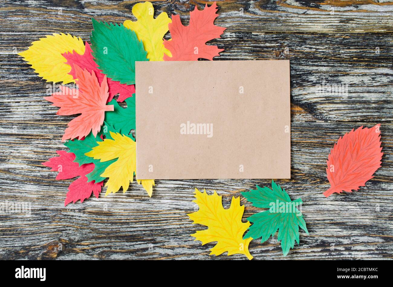 Taccuino bianco e foglie di carta autunnale su sfondo di legno vintage. Autunno, autunno concetto. Foto Stock