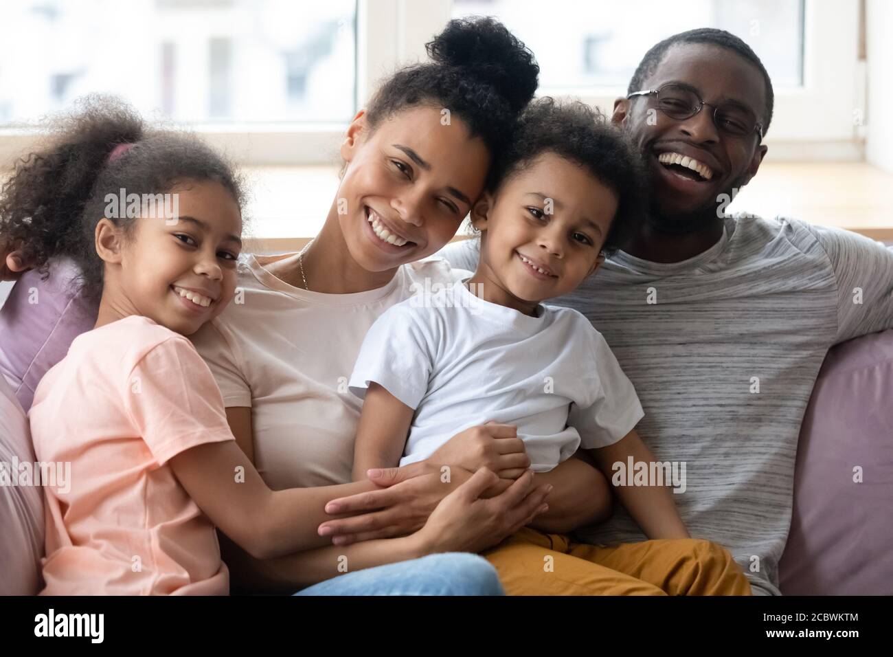Ritratto di famiglia di felice papà africano, mamma e due bambini Foto Stock