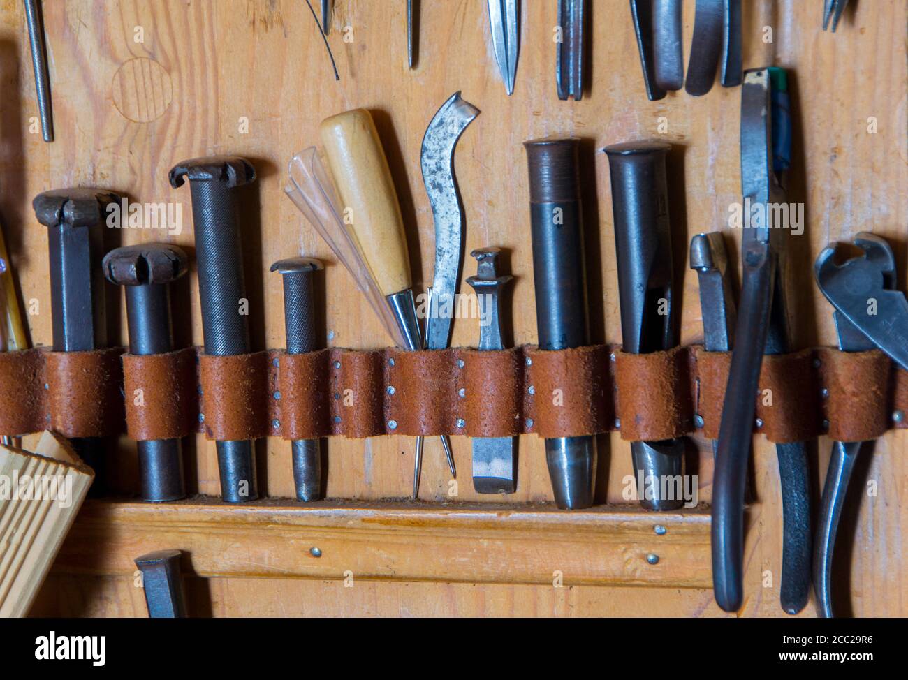 Fatte a mano in pelle strumento artigianale sul backgrounde in legno Foto Stock