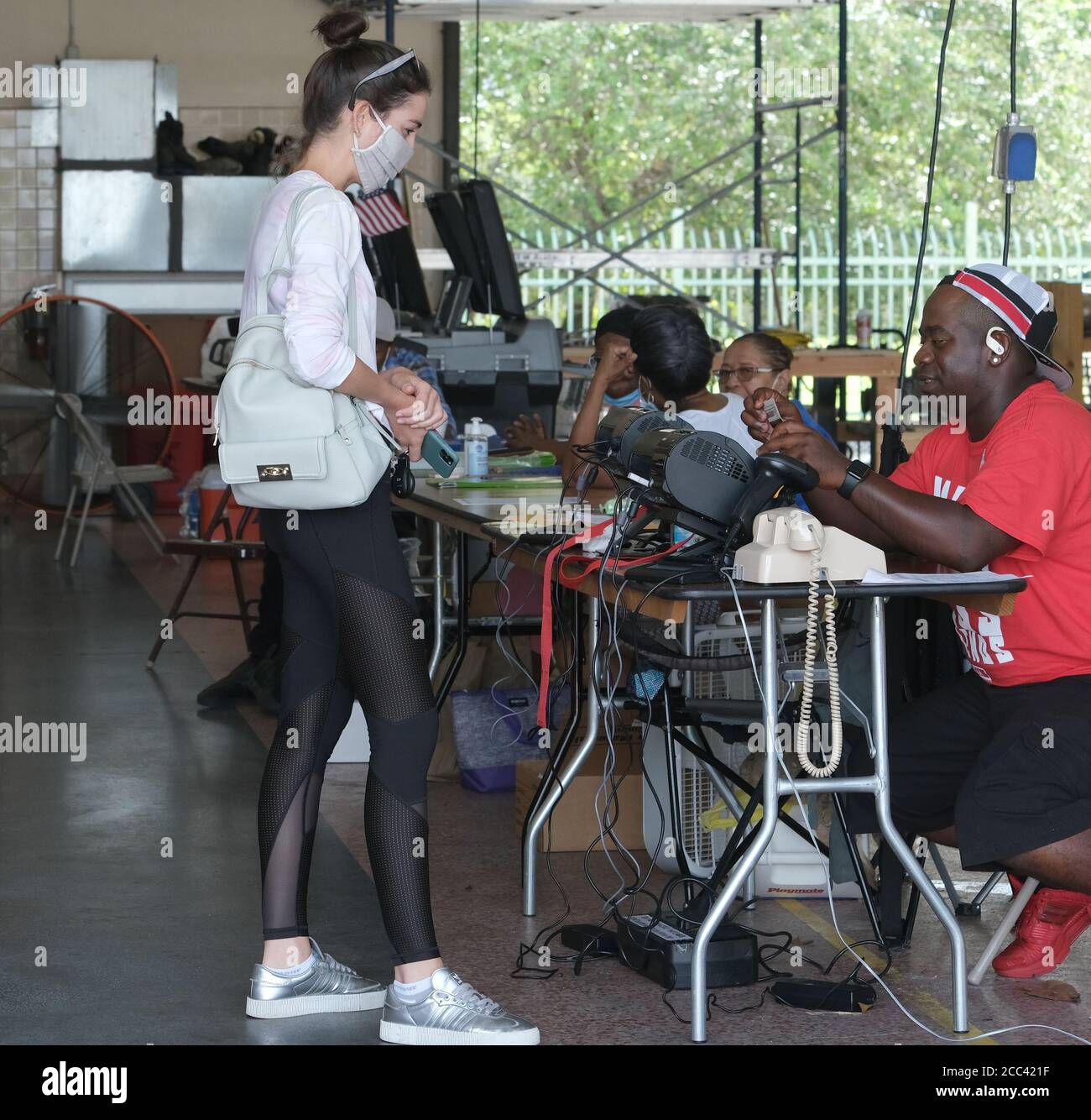 Miami, Stati Uniti. 18 agosto 2020. I residenti di Miami in Florida si accingono al banco di registrazione e hanno fatto il loro voto il giorno delle elezioni primarie per i candidati alla stazione Miami Fire and Rescue 2 di Miami, Florida, martedì 18 agosto 2020. Le linee dei siti di polling sono più brevi e in alcuni casi inesistenti a causa del COVID-19, Coronavirus Pandemic. Foto di Gary i Rothstein/UPI Credit: UPI/Alamy Live News Foto Stock