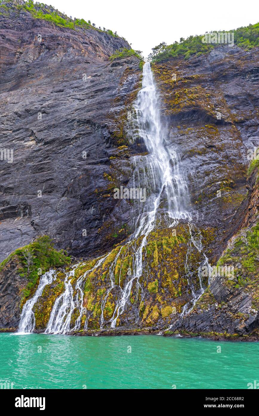 Paesaggio verticale di una cascata lungo il fiordo di ultima speranza (Last Hope Sound), il parco nazionale Bernardo o'Higgins, Patagonia, Cile. Foto Stock