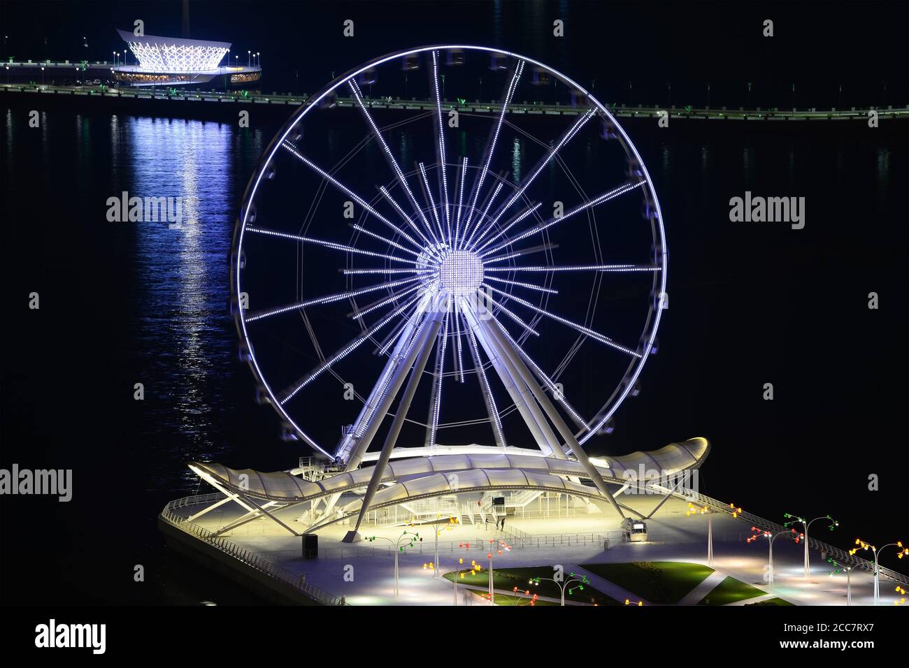 Ruota panoramica di Baku situata su Baku Boulevard in Azerbaigian. Baku Eye che gira di notte. Esposizione prolungata della ruota in ferro. Foto Stock