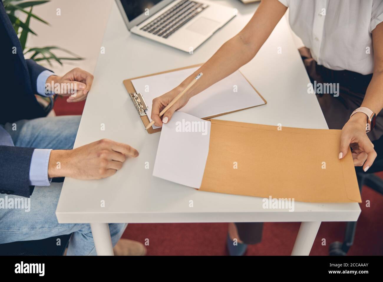 Giovane donna e uomo che lavora con documenti in ufficio Foto Stock