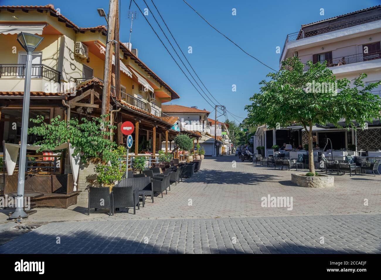 CHALKIDIKI, Grecia quasi vuoto sedie e tavoli da caffè dopo nuove misure covid-19. Area salotto all'aperto con alcuni clienti al villaggio di Hanioti. Foto Stock
