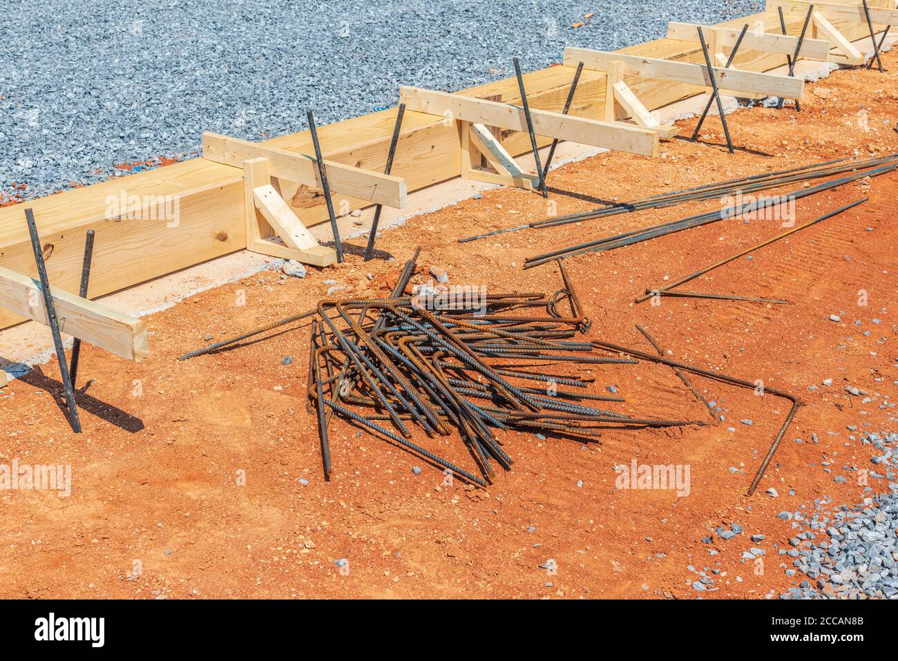 Getto orizzontale di framing in legno e aste di ferro in preparazione per calcestruzzo da versare per la fondazione. Foto Stock