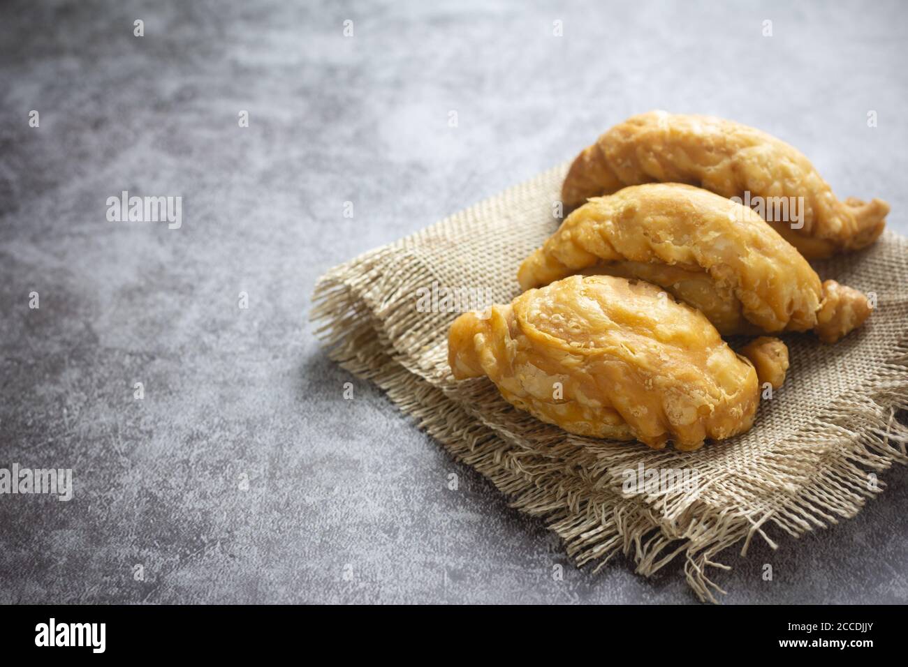 Pasta sfoglia al curry su fondo di cemento. Foto Stock