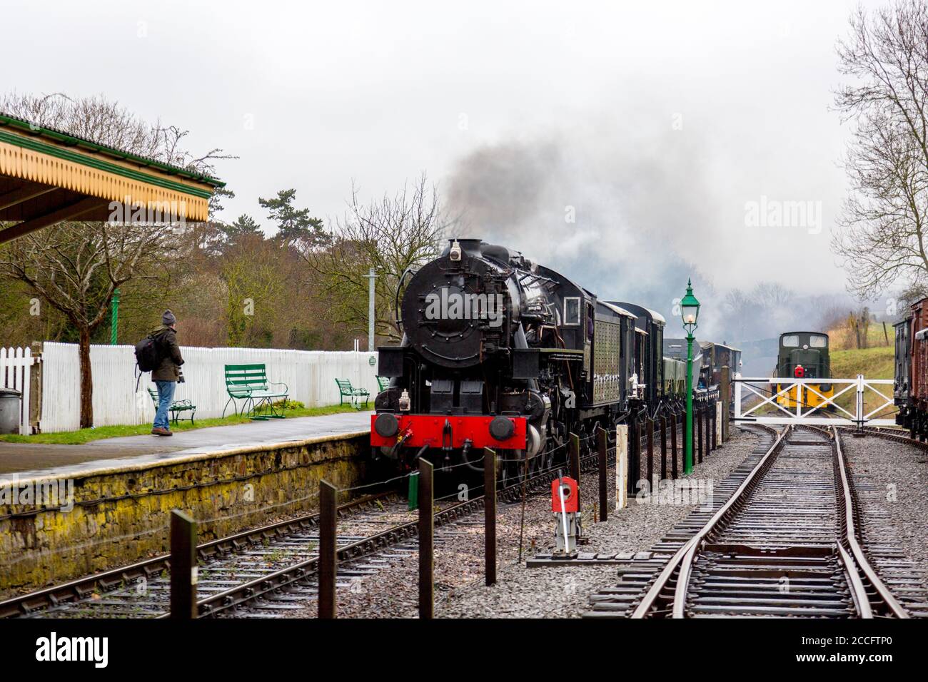 Ex-USA S160 Steam loco 6046 passando attraverso la stazione di Washford con un treno merci, West Somerset Railway Spring Gala, Inghilterra, Regno Unito Foto Stock