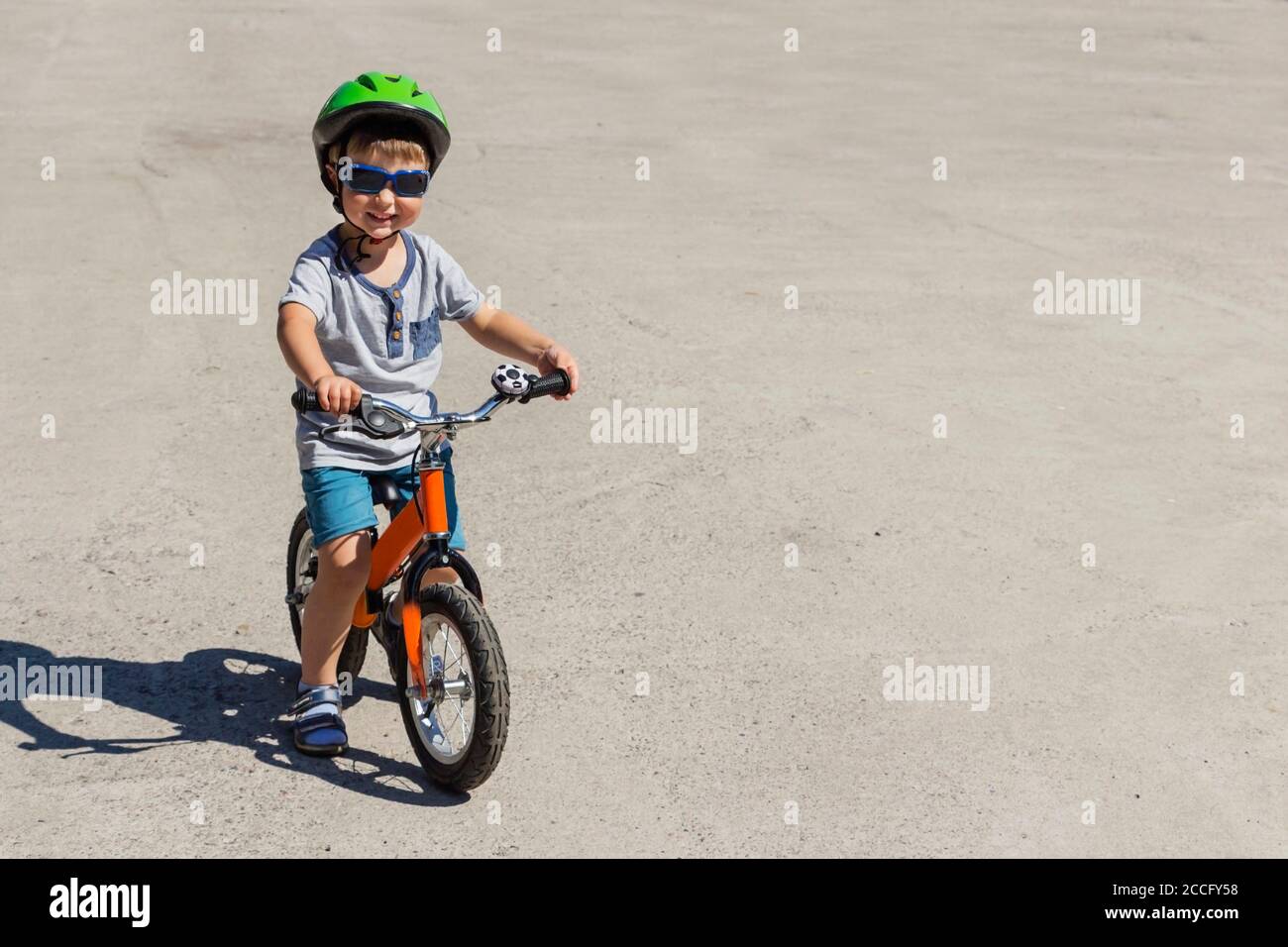 Bambino in bicicletta a bordo del casco Foto Stock