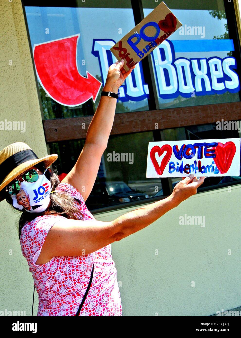 la donna californiana Waves firma una protesta contro la soppressione del voto da parte dell'Ufficio postale degli Stati e supporto per biden Foto Stock