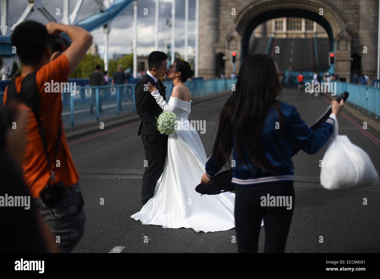 Jenny Nguyen e Tony Cao, dal Vietnam, posano per le foto di nozze sul Tower Bridge, Londra, in quanto rimane chiuso ai veicoli dopo che è stato bloccato aperto per più di un'ora il sabato a causa di un 'guasto meccanico'. Foto Stock
