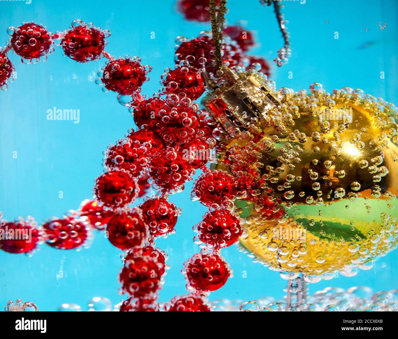 Palla di Natale in acqua con bolle, concetto di carta di Natale Foto Stock