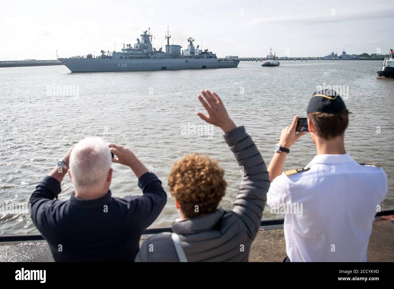 Wilhelmshaven, Germania. 25 Agosto 2020. I membri dell'equipaggio si sono ondulati all'uscita della fregata 'Brandenburg'. La fregata sostituisce l'Einsatzgrupppenversorger "Berlin". In collaborazione con la guardia costiera turca e greca e con l'Agenzia europea per la protezione della costa e delle frontiere (Frontex), controlla la zona marittima. Credit: Sina Schuldt/dpa/Alamy Live News Foto Stock