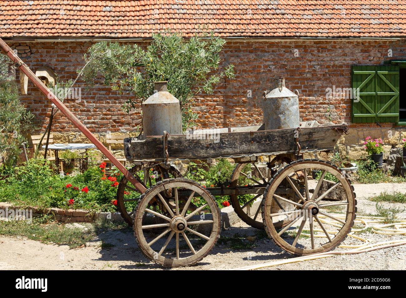 Vecchia carrozza a cavallo della milkmaid, barile di latte di ferro Foto Stock
