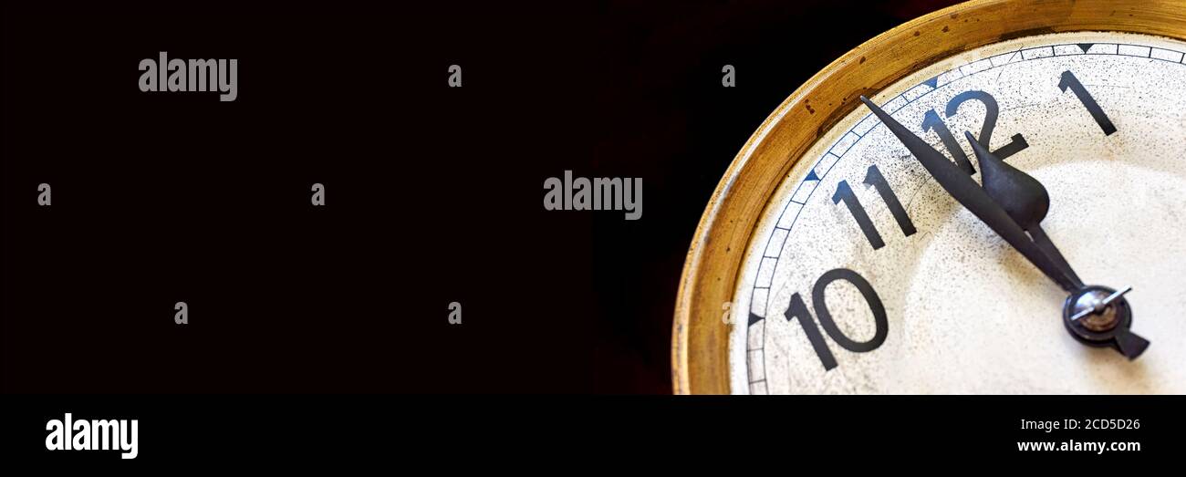 Orologio vecchio vintage mostra 2 minuti a 12 su uno sfondo nero. Banner di Capodanno o conto alla rovescia con spazio per la copia. Foto Stock